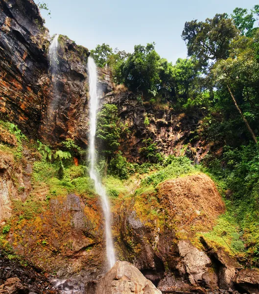 Sacred waterfall in a deep canyon of tropical forest