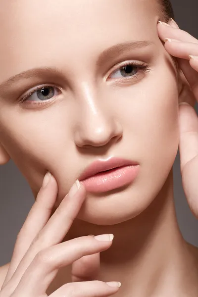 Make-up & cosmetics, manicure. Closeup portrait of beautiful woman model face with clean skin, full glossy lips. Natural skincare beauty, clean soft skin, french manicure