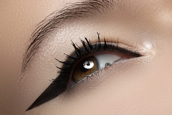 Cosmetics & make-up. Beautiful female eye with black liner make-up