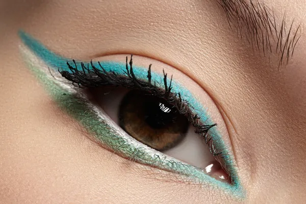 Elegance close-up of beautiful female eye with fashion trend mint colors eyeshadow and eyeliner. Macro shot of beautiful woman\'s face part with makeup. Cosmetics, beauty and make-up