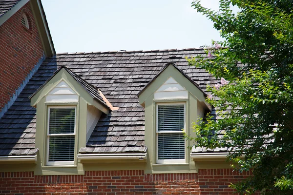Two Dormers on Brick Homes with Wood Shingles