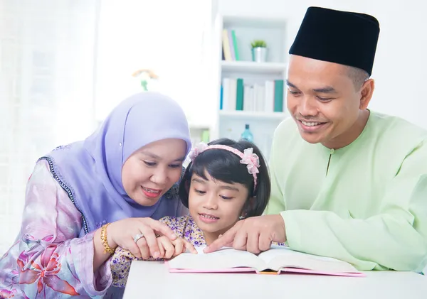 Muslim family reading book
