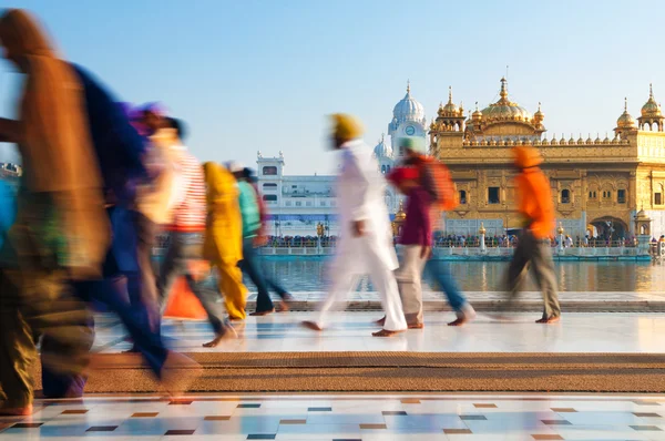 Group of Sikh pilgrims walking by the Golden Temple