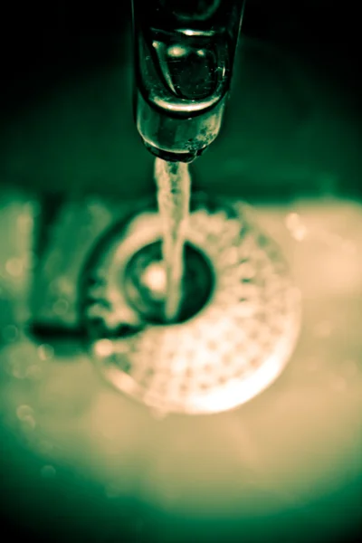 Water dripping from water tap , artistic retro style toned photo