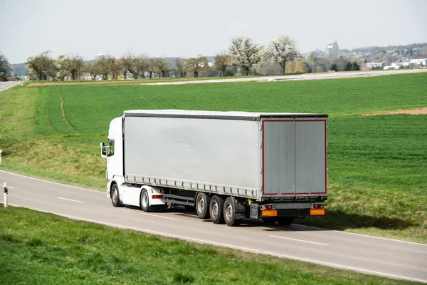 White truck moving on a main road