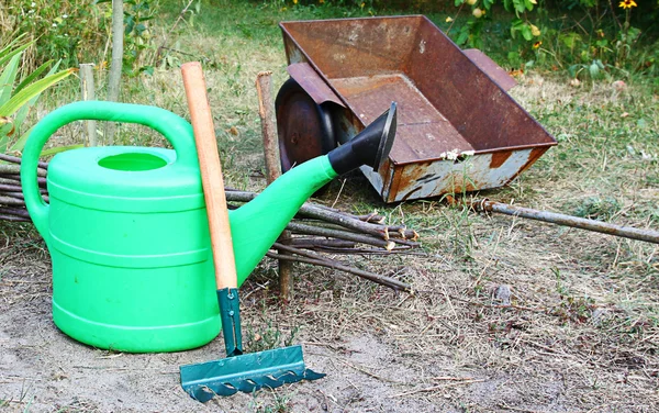 Tools for work in a garden is a watering-can and wheelbarrow