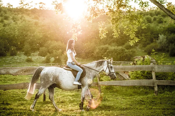 Woman getting ready for horseback riding