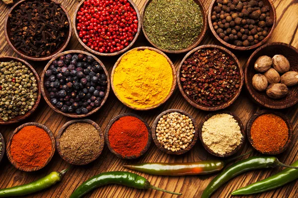 Spices and herbs in wooden bowls.