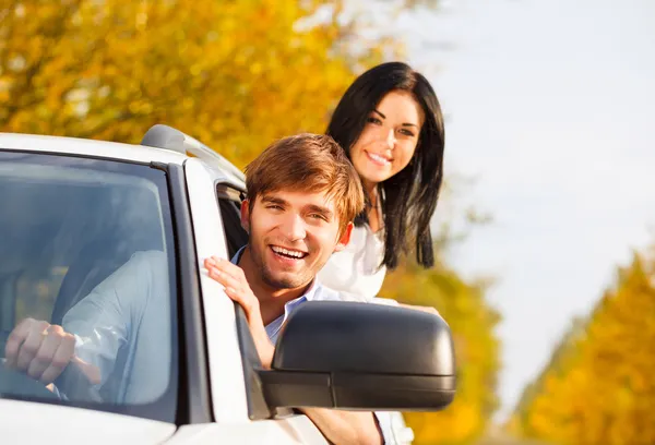 Young smile couple driving car