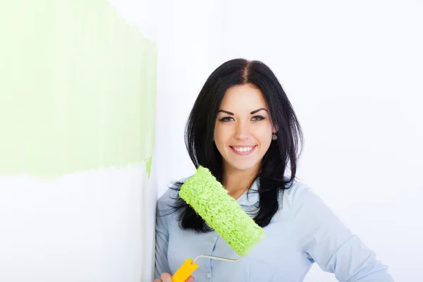 Woman smile paint in green color white wall