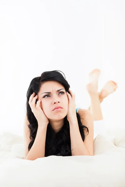 Woman lying think relaxing on the bed