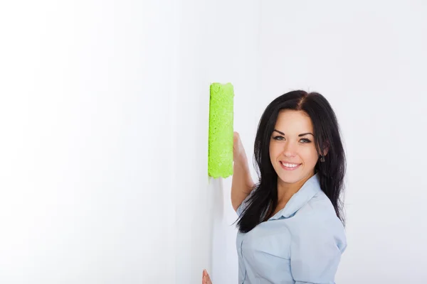 Woman smile paint in green color white wall