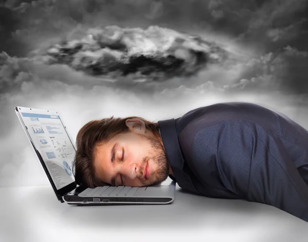 Businessman lying head on laptop