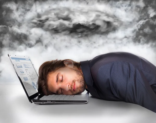 Businessman lying head on laptop