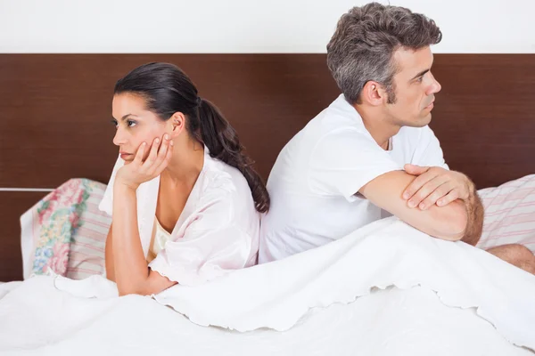 Unhappy couple in bed