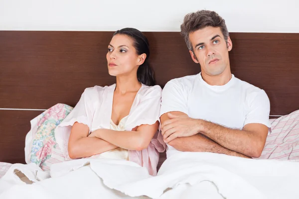 Unhappy couple in bed