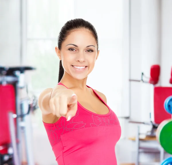 Fitness woman pointing