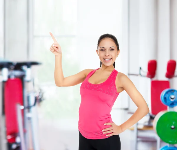 Fitness woman pointing