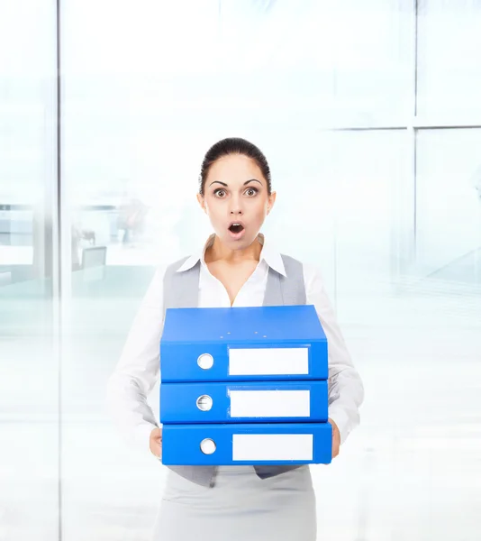 Businesswoman  holding stack of folders