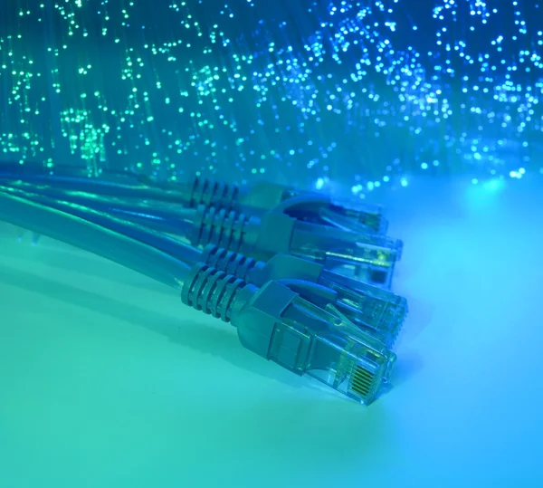 Network cable closeup with fiber optical background