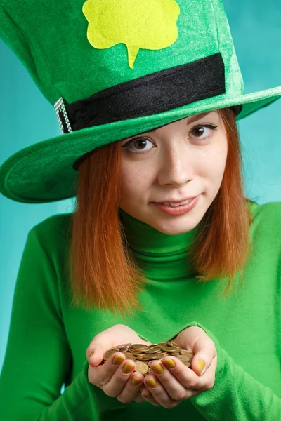 Red hair girl in Saint Patrick's Day leprechaun party hat with g