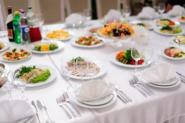 Table set service with silverware and glass stemware at restaurant before party