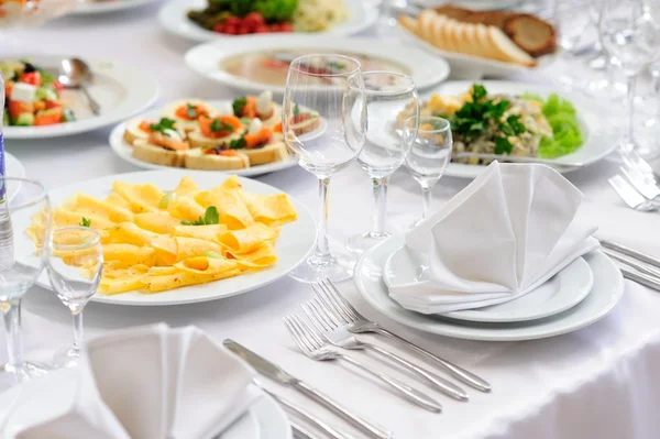 Table set service with silverware and glass stemware at restaurant before party