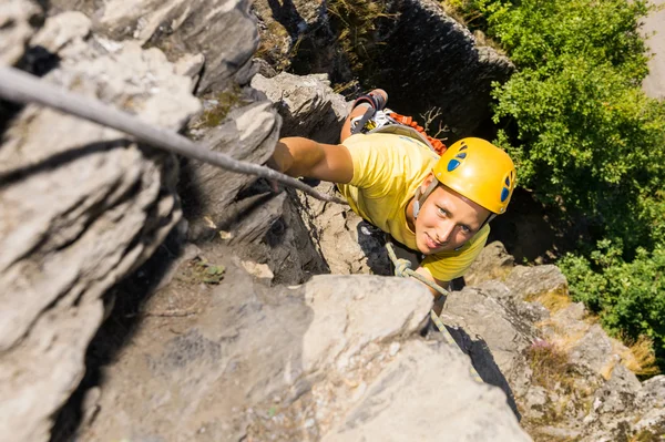 Young Man Climbing Rock