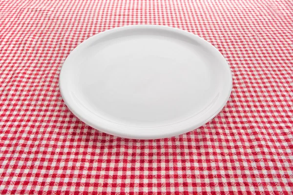 Empty plate on kitchen table — Stock Photo #21381593