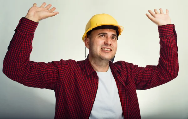 Construction worker with raised hands