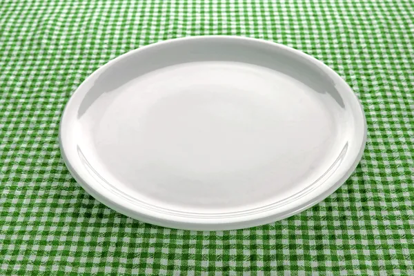 Empty plate on kitchen table