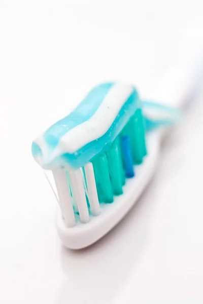 Tooth paste on brush, close up