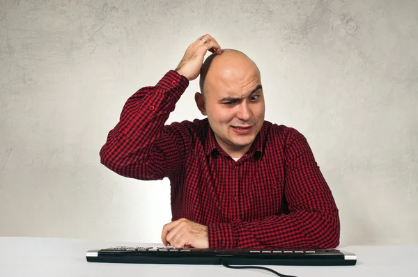 Confused man at office table