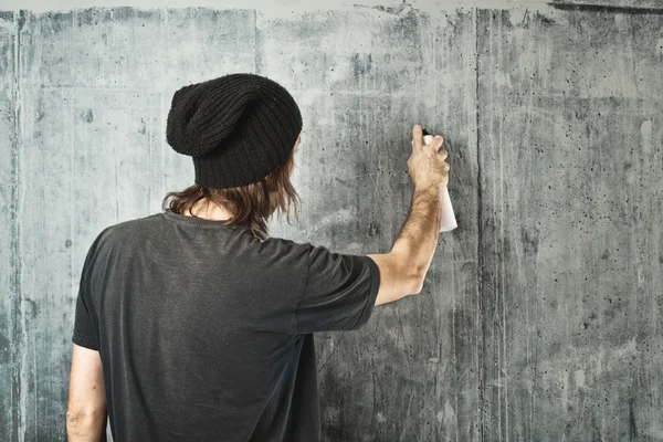 Graffiti artist spraying the wall