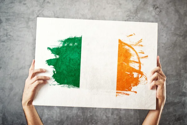 Ireland flag. Man holding banner with Irish Flag.