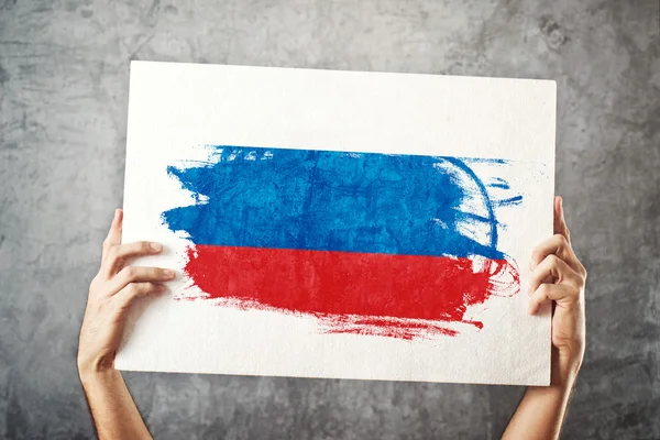 Russia flag. Man holding banner with Russian Flag.