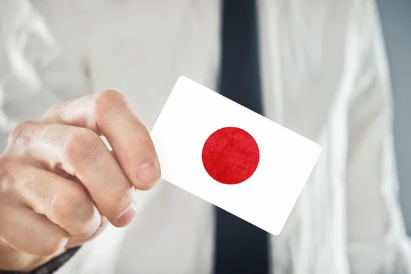 Japanese Businessman holding business card with Japan Flag