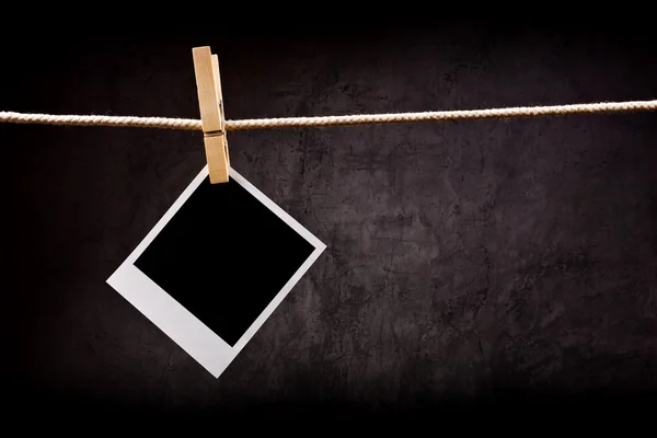 Photography paper with instant photo frame attached to rope with