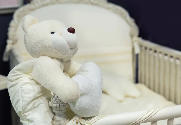 Baby bedroom with white teddy bear