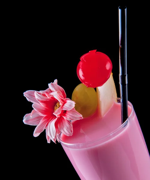 Alcohol pink drink, cocktail with flower, straw, isolated black