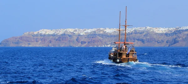 Tourists boat going to Oia, Santorini, Greece