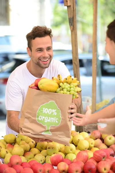 Small business owner selling organic fruits and vegetables