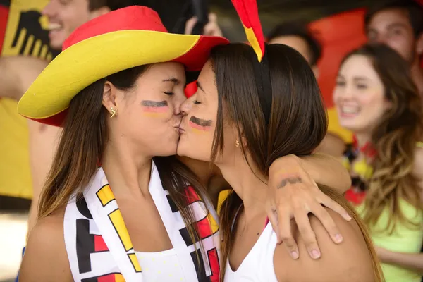 Cheerful couple of german lesbian soccer fans