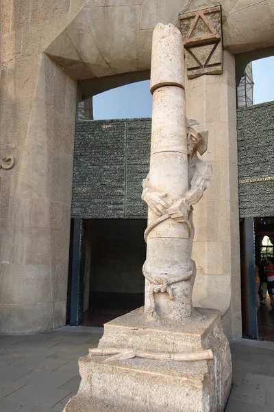 Statue of Jesus and a stone pillar by Gaudi at Sagrada Familia