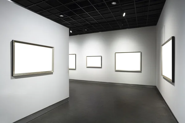Frames on white wall in art museum — Stock Photo #16809661