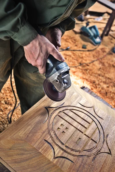 Worker carving wood