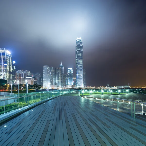 Pathway in the night with modern city background