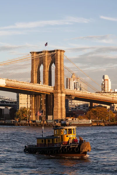 Brooklyn bridge and small ship in new york city