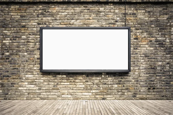 Blank billboard on old brick wall