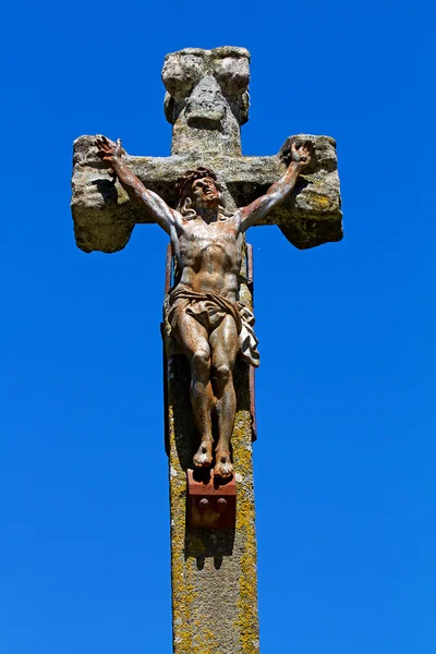 Statue of Jesus on a stone cross
